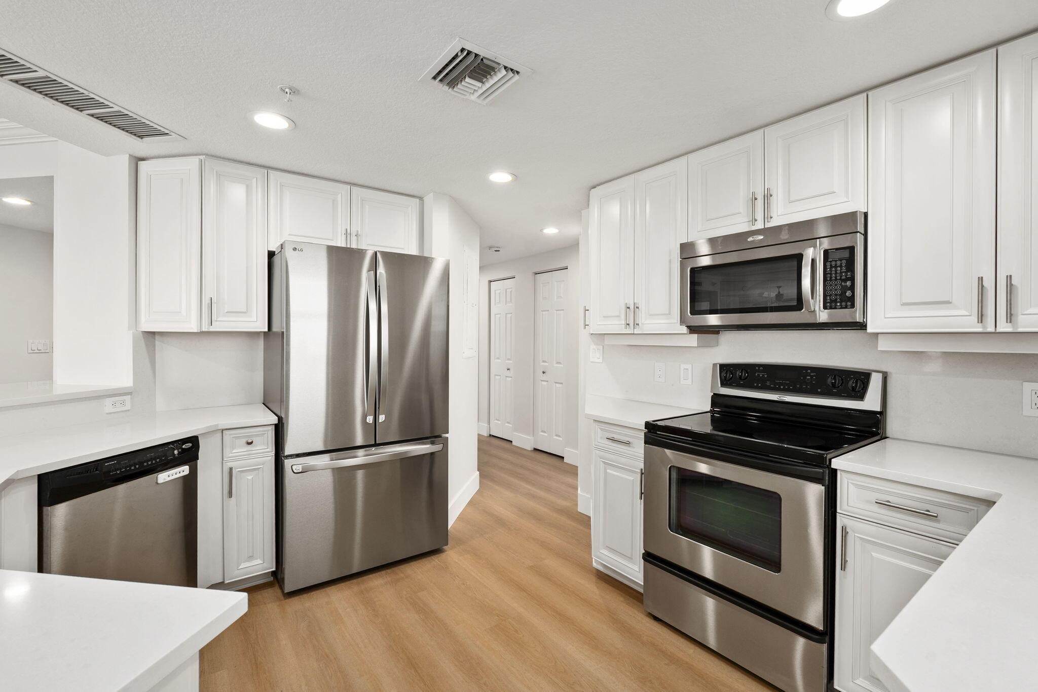 5051 North Hwy A1A, Unit PH24 Fort Pierce, FL 34949 - Photo 16 of 50 a kitchen with wooden cabinets and stainless steel appliances