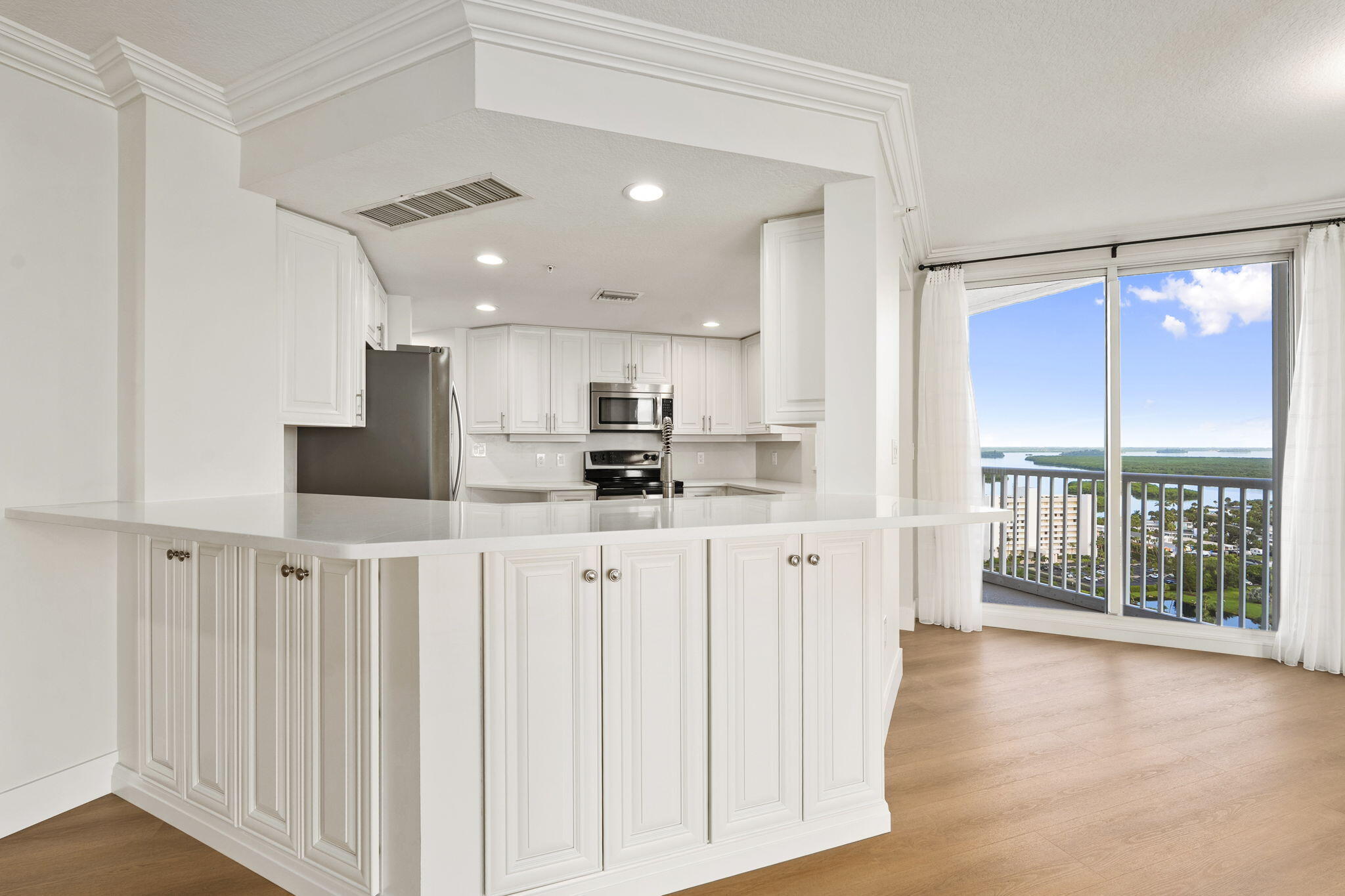 5051 North Hwy A1A, Unit PH24 Fort Pierce, FL 34949 - Photo 17 of 50 a view of kitchen with wooden floor