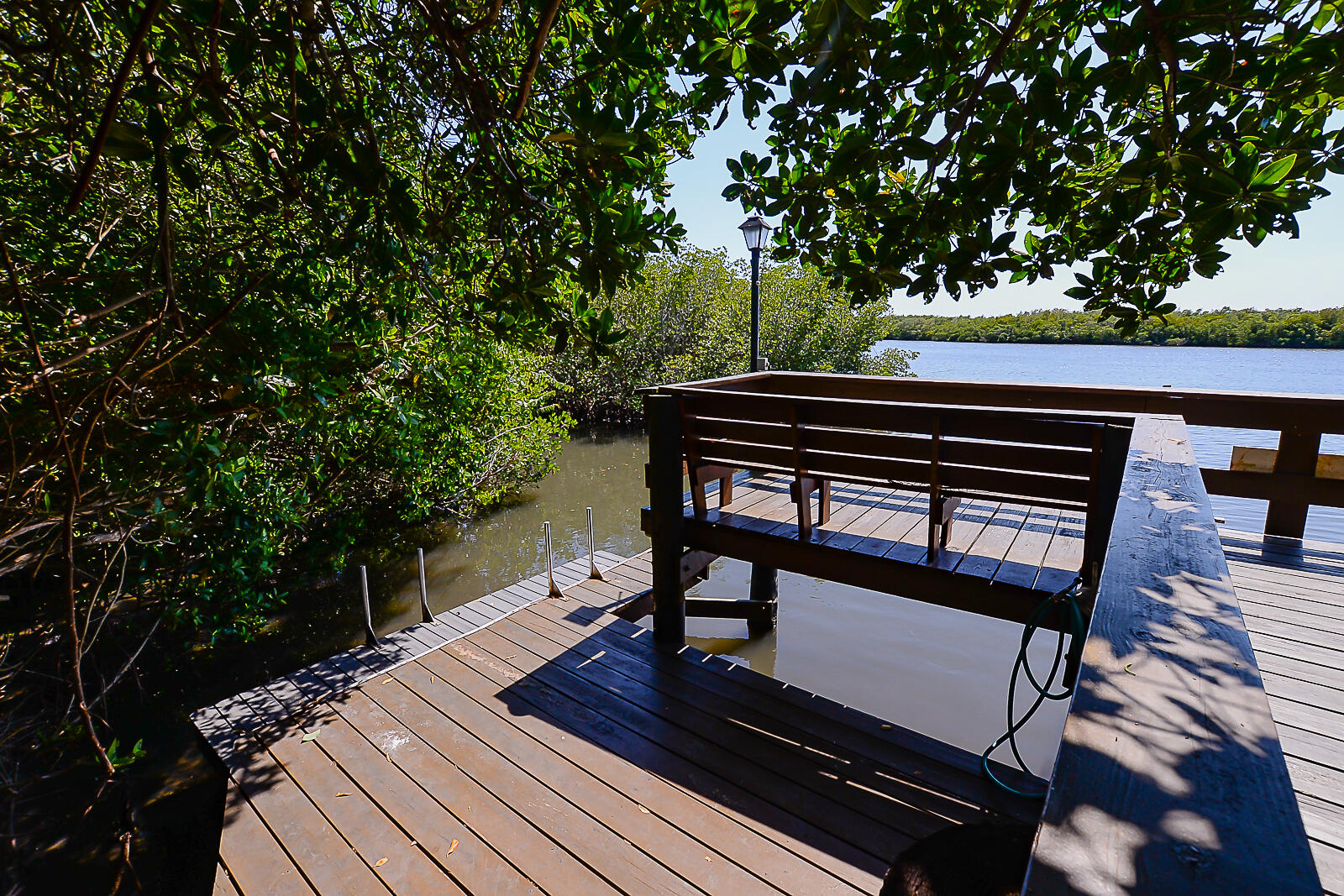 5051 North Hwy A1A, Unit PH24 Fort Pierce, FL 34949 - Photo 18 of 50 a view of sitting area with benches sitting below a tree