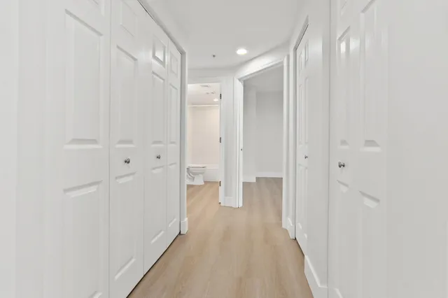 a view of a bathroom with mirror and shower