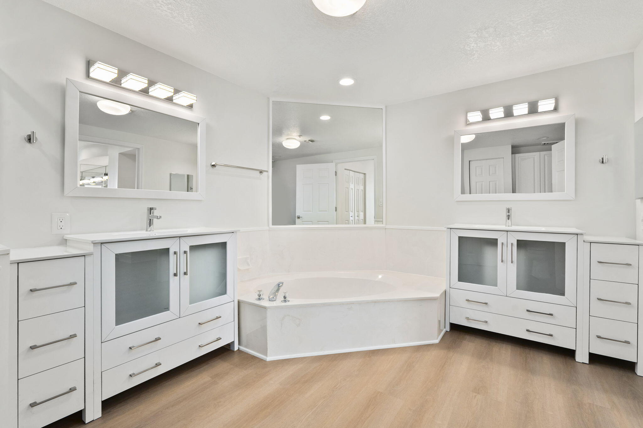 5051 North Hwy A1A, Unit PH24 Fort Pierce, FL 34949 - Photo 40 of 50 a bathroom with a double vanity sink a mirror and a bathtub