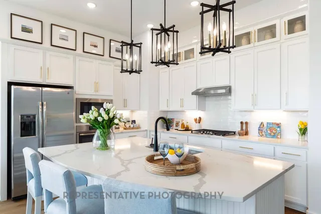 a kitchen with stainless steel appliances kitchen island granite countertop a sink and cabinets
