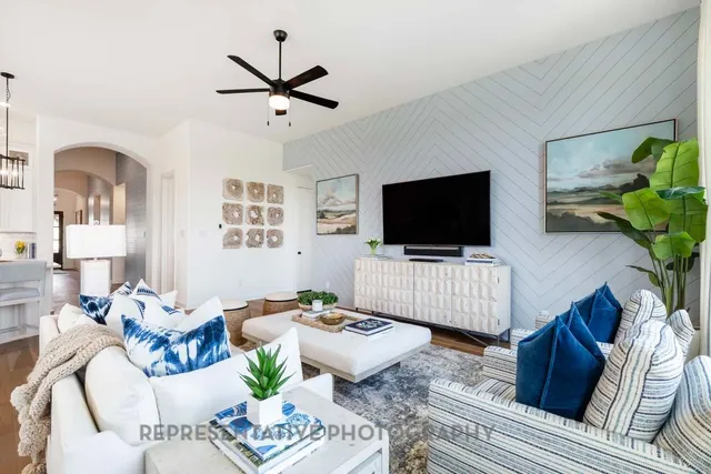 a living room with furniture and a flat screen tv