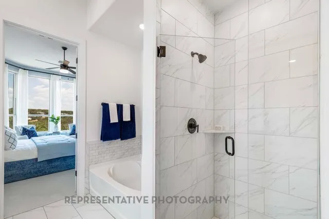 a view of double vanity sink a mirror a window and a shower