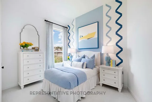 a bedroom with a bed and a painting on the wall