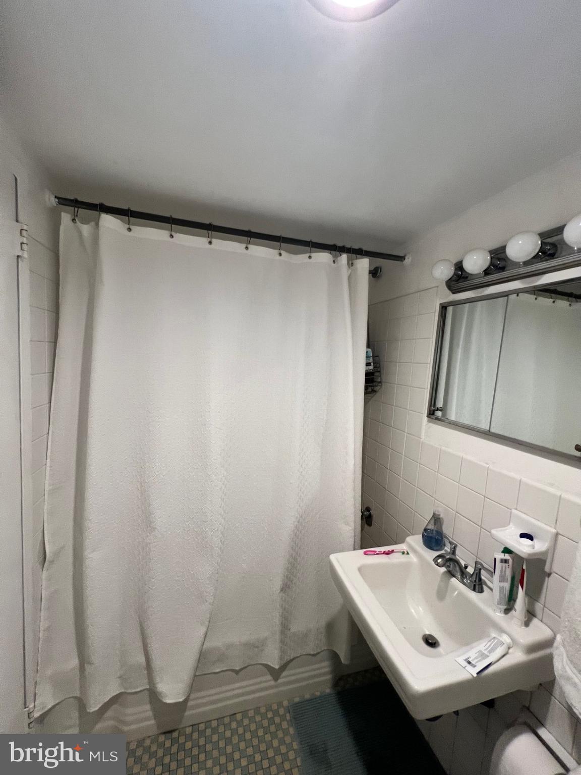 224 West Rittenhouse Square, Unit 1202 Philadelphia, PA 19103 - Photo 6 of 17 a bathroom with a sink and a mirror