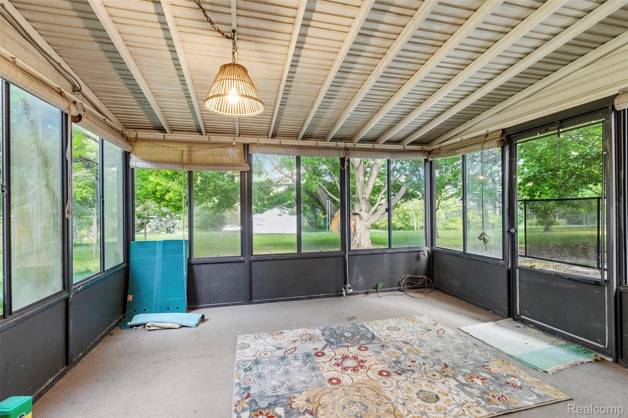 309 Windy Bluff Street Flushing, MI 48433 - Photo 21 of 32 Enclosed sunroom featuring a paneled ceiling, full-height windows, a glass-paneled door, and an overhead light fixture