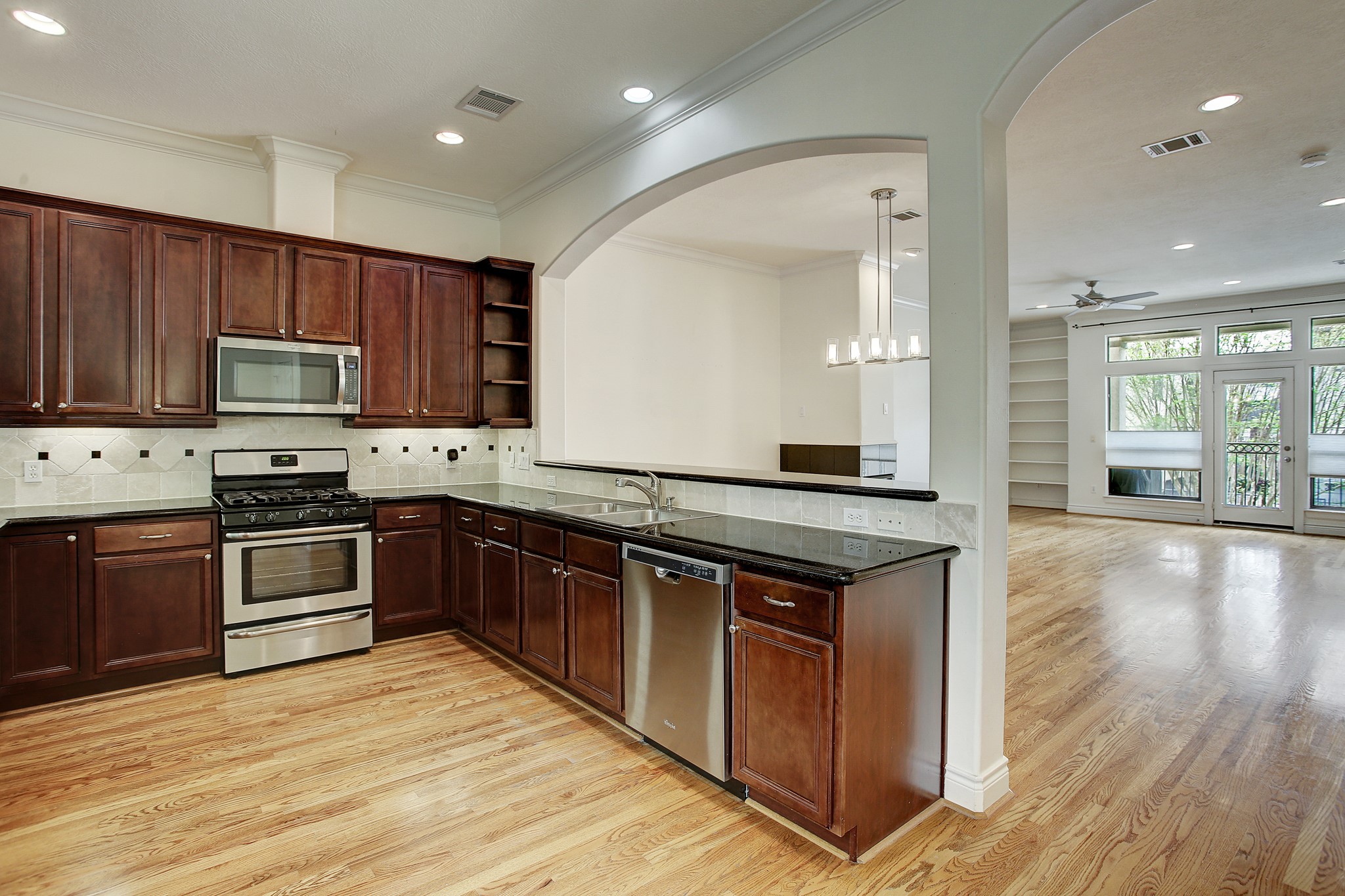 1403 Rosedale Street Houston, TX 77004 - Photo 11 of 18 a kitchen with stainless steel appliances granite countertop a stove a sink and a microwave