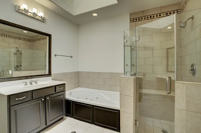 a bathroom with a sink a mirror and a shower