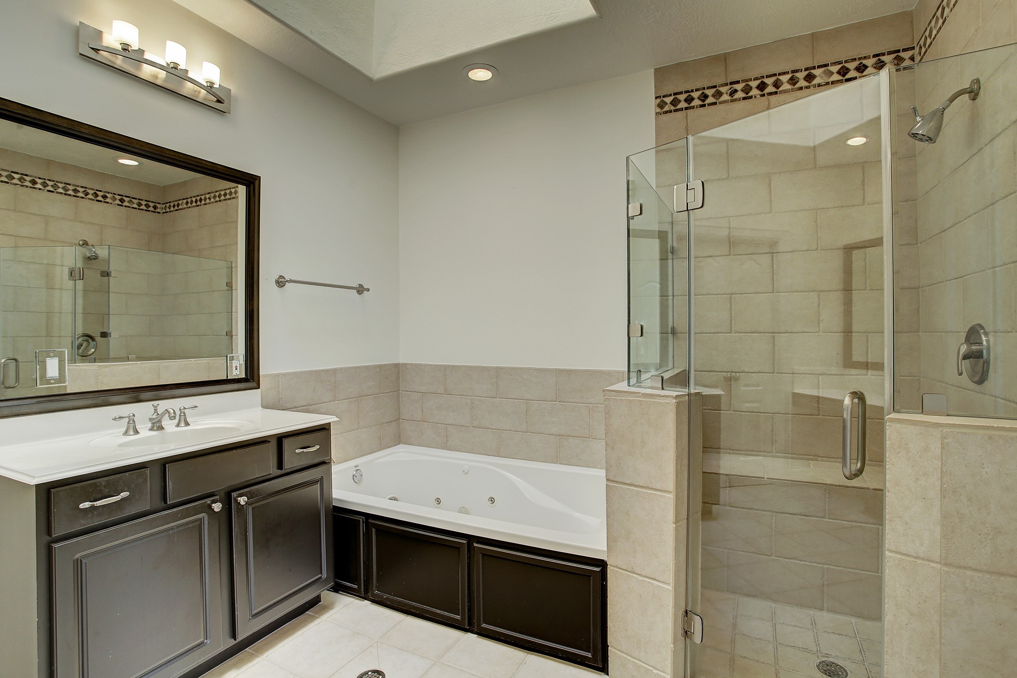 1403 Rosedale Street Houston, TX 77004 - Photo 16 of 18 a bathroom with a sink a mirror and a shower
