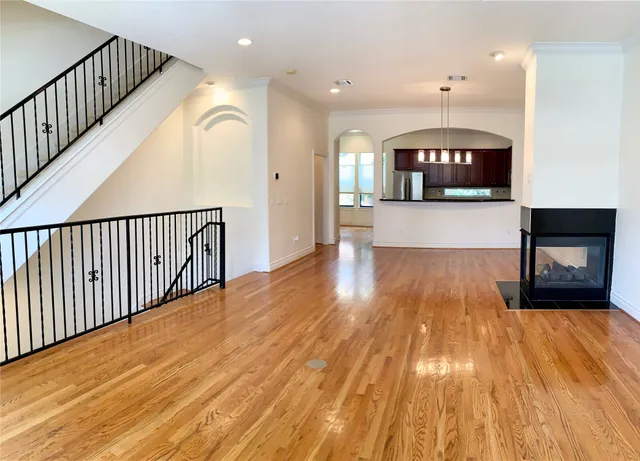 a view of livingroom with kitchen and a fireplace