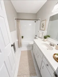 a spacious bathroom with a double vanity sink and a mirror