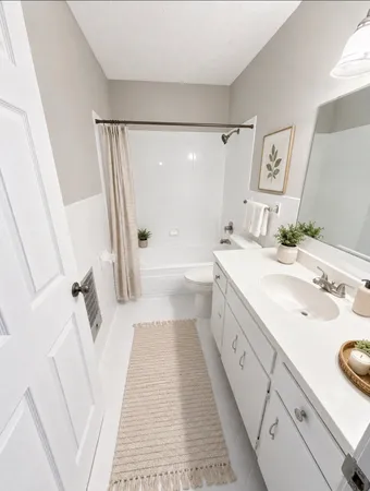 a spacious bathroom with a double vanity sink and a mirror