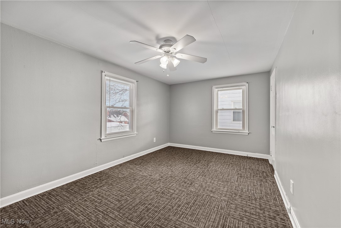 4041 Wilmington Road Cleveland, OH 44121 - Photo 20 of 38 Spare room with dark carpet, plenty of natural light, and ceiling fan