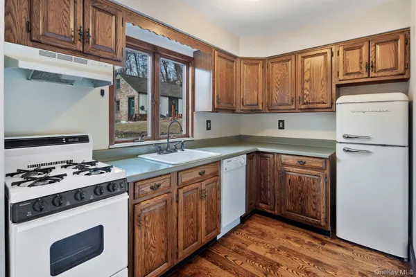 a kitchen with stainless steel appliances granite countertop a stove sink and cabinets
