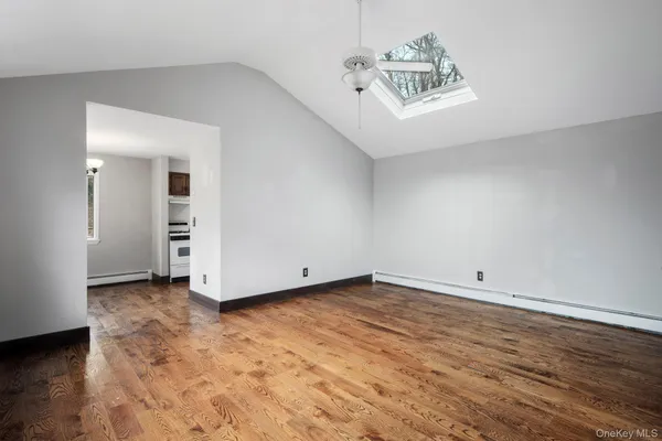 a view of a room with wooden floor and white walls