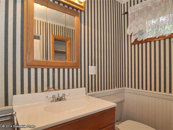 127 Fish Road Tiverton, RI 02878 - Photo 23 of 30 a bathroom with a sink a toilet and mirror