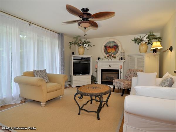127 Fish Road Tiverton, RI 02878 - Photo 26 of 30 a living room with furniture a fireplace and a flat screen tv