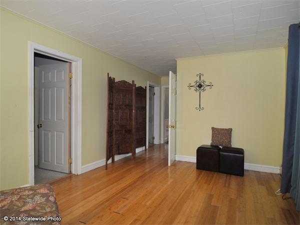 127 Fish Road Tiverton, RI 02878 - Photo 30 of 30 a view of a bedroom with a bed and wooden floor