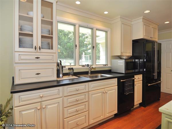 127 Fish Road Tiverton, RI 02878 - Photo 5 of 30 a kitchen with stainless steel appliances white cabinets and a window