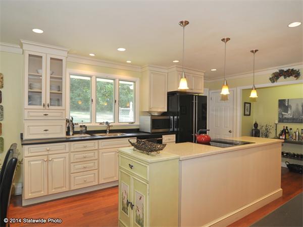 127 Fish Road Tiverton, RI 02878 - Photo 7 of 30 a kitchen that has a sink a stove and a refrigerator