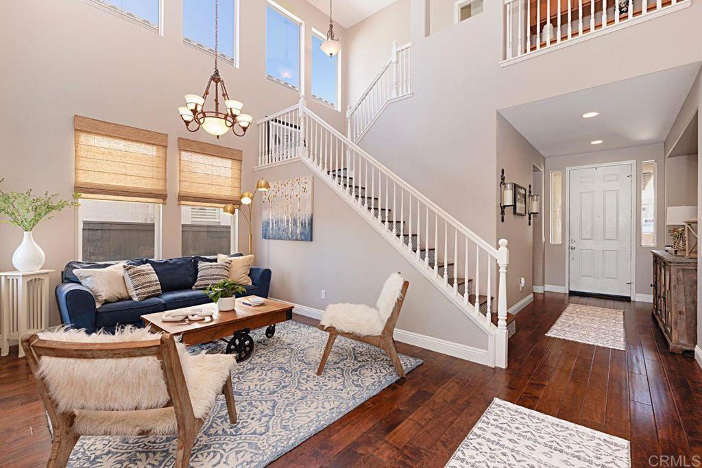 1672 Sagewood Way San Marcos, CA 92078 - Photo 12 of 61 a living room with furniture and a chandelier