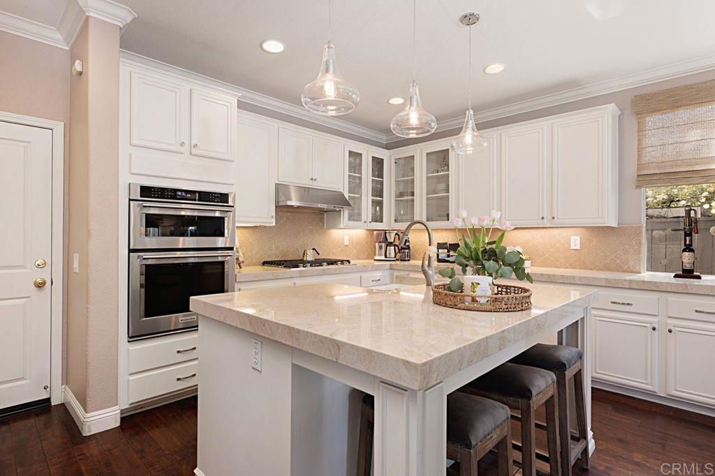 1672 Sagewood Way San Marcos, CA 92078 - Photo 19 of 61 a kitchen with a sink a stove a microwave and cabinets