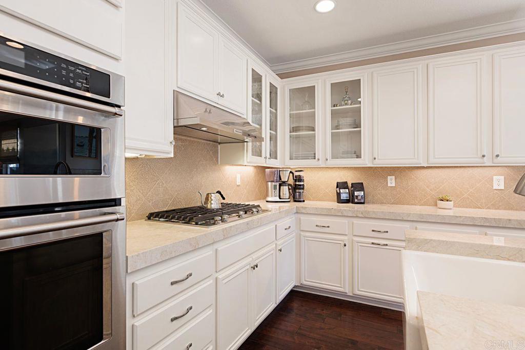 1672 Sagewood Way San Marcos, CA 92078 - Photo 20 of 61 a kitchen with stainless steel appliances white cabinets and a stove top oven