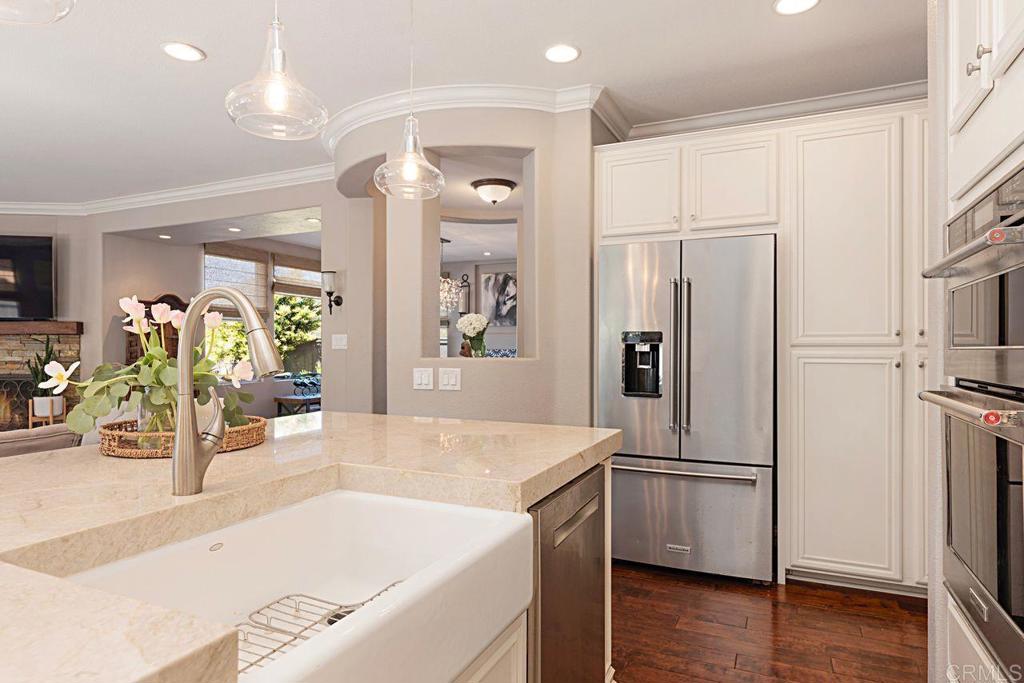 1672 Sagewood Way San Marcos, CA 92078 - Photo 21 of 61 a kitchen with stainless steel appliances granite countertop a refrigerator and a sink