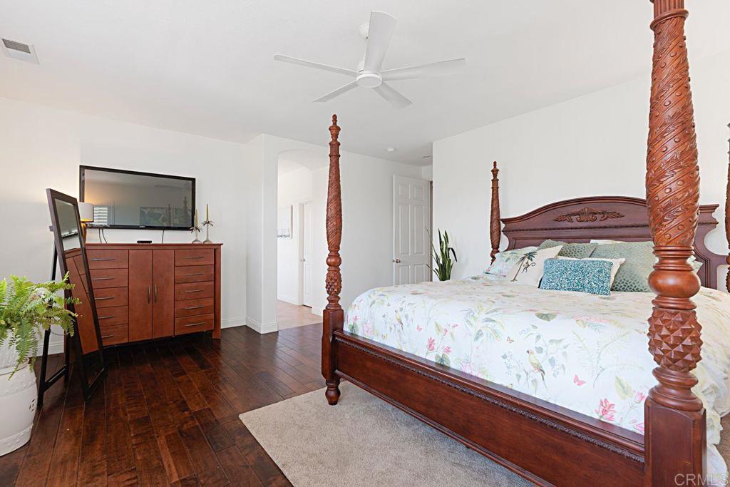 1672 Sagewood Way San Marcos, CA 92078 - Photo 30 of 61 a bedroom with a bed and wooden floor