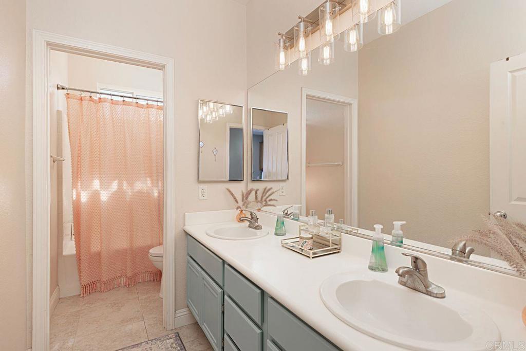 1672 Sagewood Way San Marcos, CA 92078 - Photo 36 of 61 a bathroom with a double vanity sink and a mirror