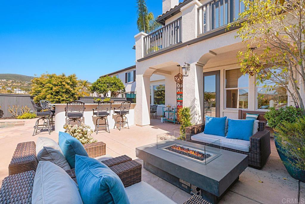 1672 Sagewood Way San Marcos, CA 92078 - Photo 42 of 61 a view of a patio with couches table and chairs with potted plants