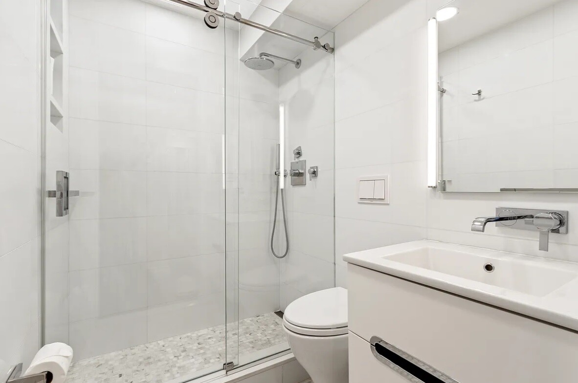 240 East 76th Street, Unit 6V Manhattan, NY 10021 - Photo 5 of 7 a bathroom with a sink toilet and shower