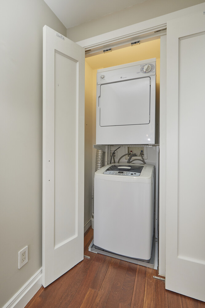 240 East 76th Street, Unit 6V Manhattan, NY 10021 - Photo 6 of 7 a room with wooden floor and a window