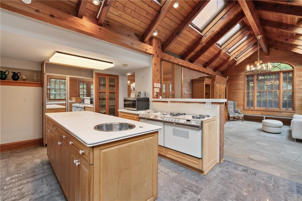 5238 Ellsworth Avenue Pittsburgh, PA 15232 - Photo 12 of 47 a kitchen that has a sink a stove and a wooden floor