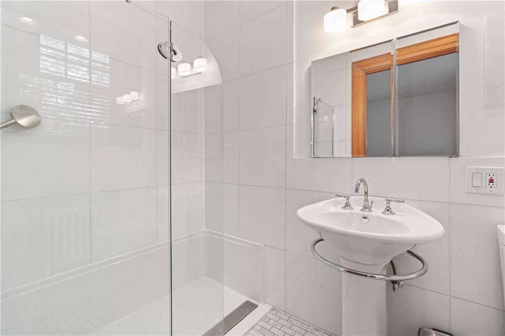 5238 Ellsworth Avenue Pittsburgh, PA 15232 - Photo 27 of 47 a bathroom with a sink a mirror and shower