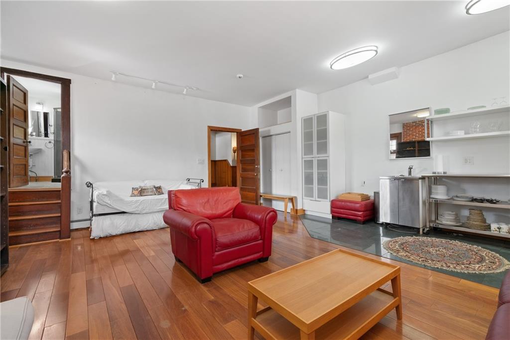 5238 Ellsworth Avenue Pittsburgh, PA 15232 - Photo 30 of 47 a living room with furniture a fireplace and large windows