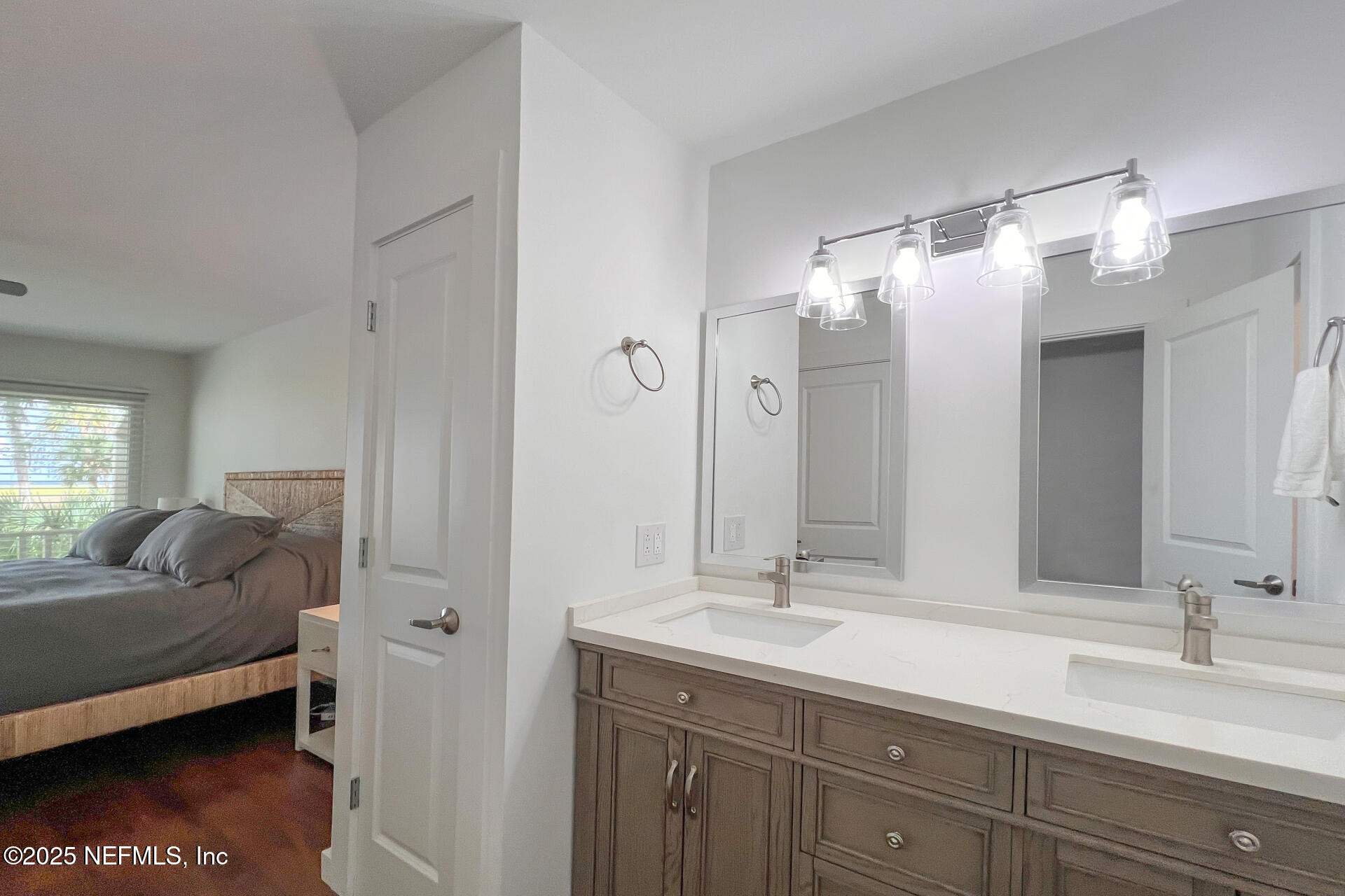 3426 Sea Marsh Road Fernandina Beach, FL 32034 - Photo 23 of 39 a en suite bathroom with a double vanity sink and mirror