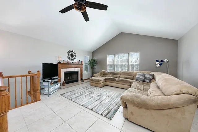 a living room with furniture fireplace and a window