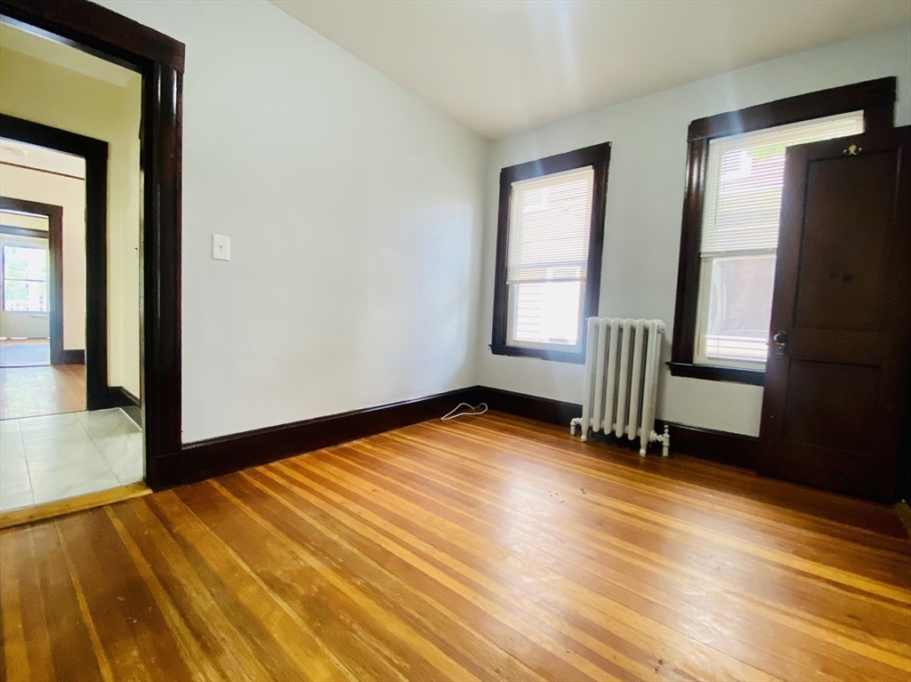 39-41 Michigan Avenue, Unit 1 Somerville, MA 02145 - Photo 11 of 27 a view of empty room with wooden floor and fan