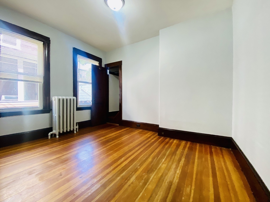 39-41 Michigan Avenue, Unit 1 Somerville, MA 02145 - Photo 12 of 27 a view of empty room with wooden floor