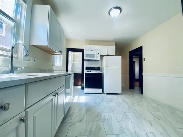 a kitchen with a refrigerator and a sink