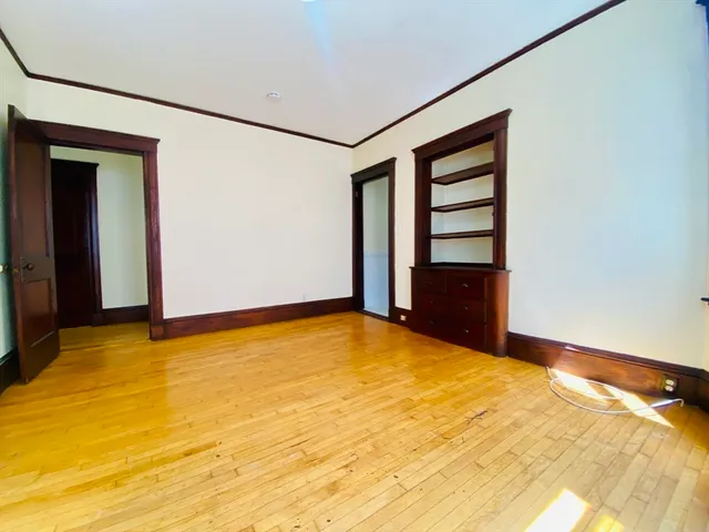 a view of an empty room with closet