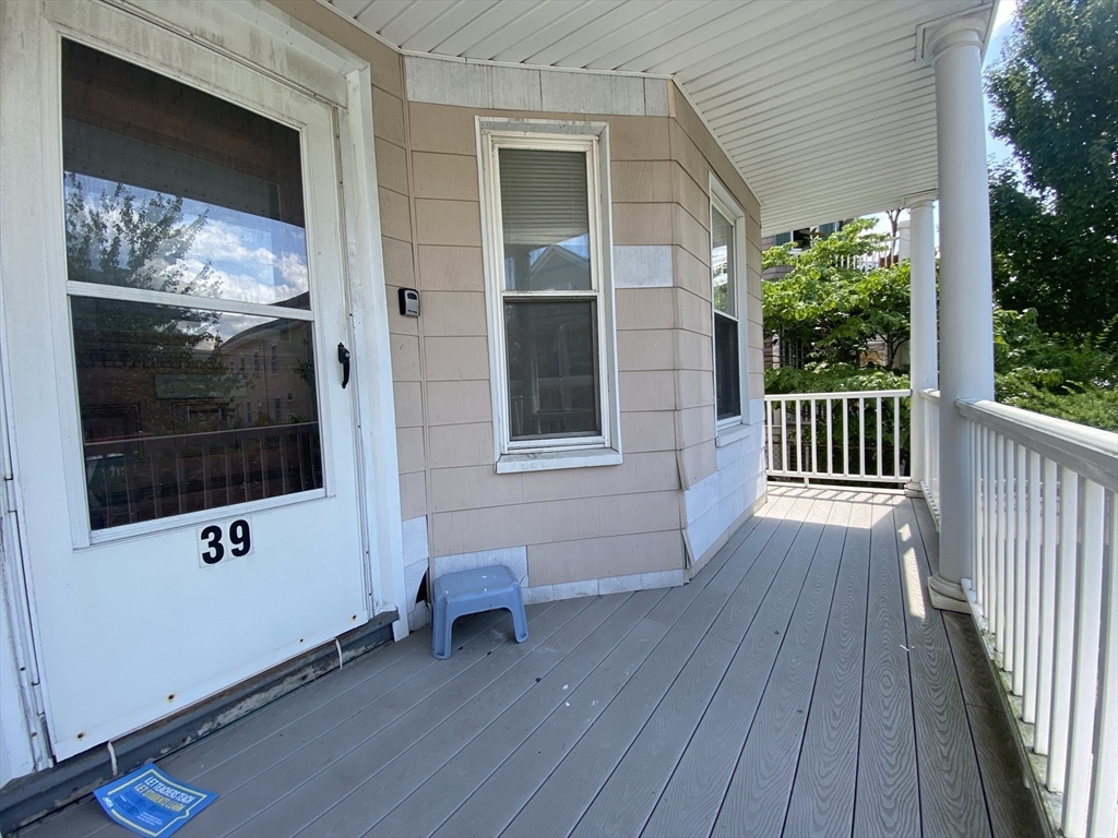 39-41 Michigan Avenue, Unit 1 Somerville, MA 02145 - Photo 27 of 27 a view of a house with a porch
