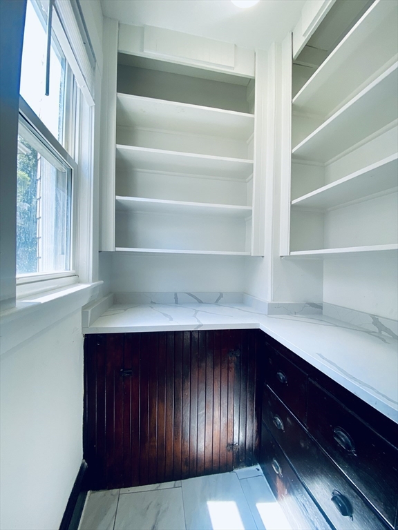 39-41 Michigan Avenue, Unit 1 Somerville, MA 02145 - Photo 4 of 27 a view of storage and utility room with cabinets