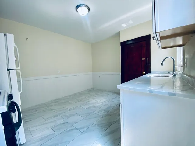 a kitchen with a sink and a refrigerator