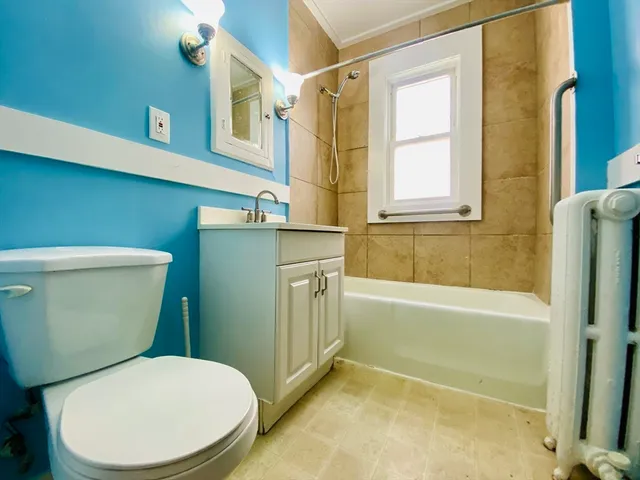 a bathroom with a toilet and a bathtub
