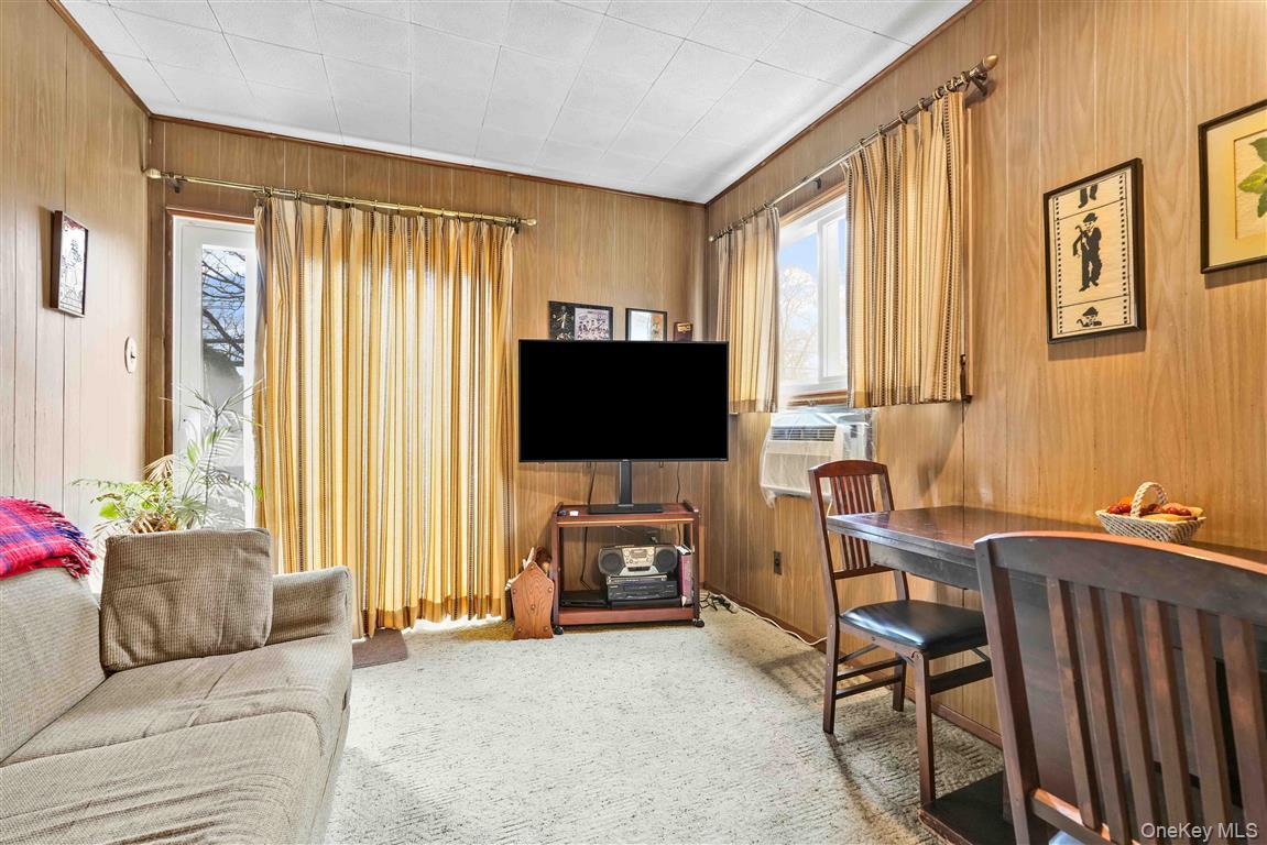 84-92 Austin Street Queens, NY 11415 - Photo 12 of 40 a living room with furniture and a flat screen tv