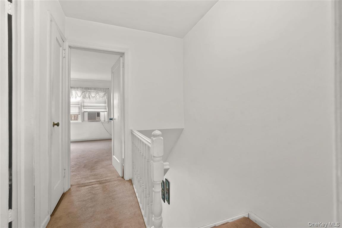 84-92 Austin Street Queens, NY 11415 - Photo 14 of 40 a view of a hallway with wooden floor and a bathroom