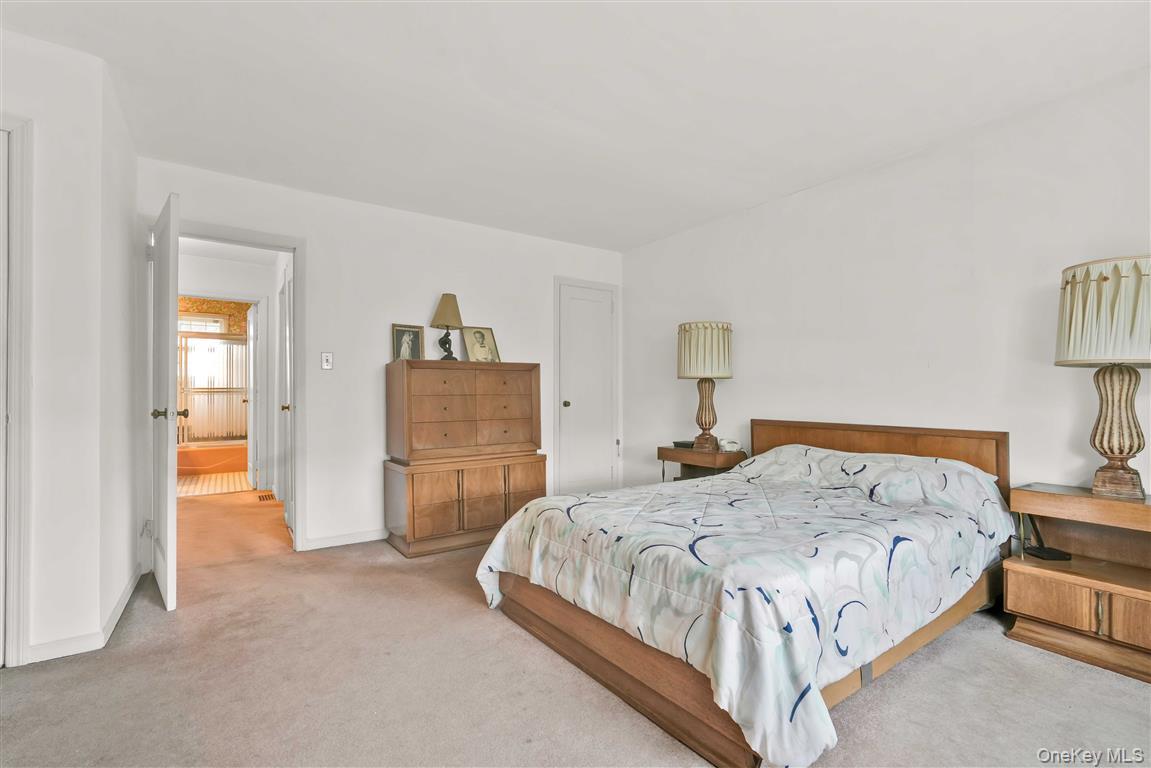 84-92 Austin Street Queens, NY 11415 - Photo 16 of 40 a bedroom with a bed and a lamp